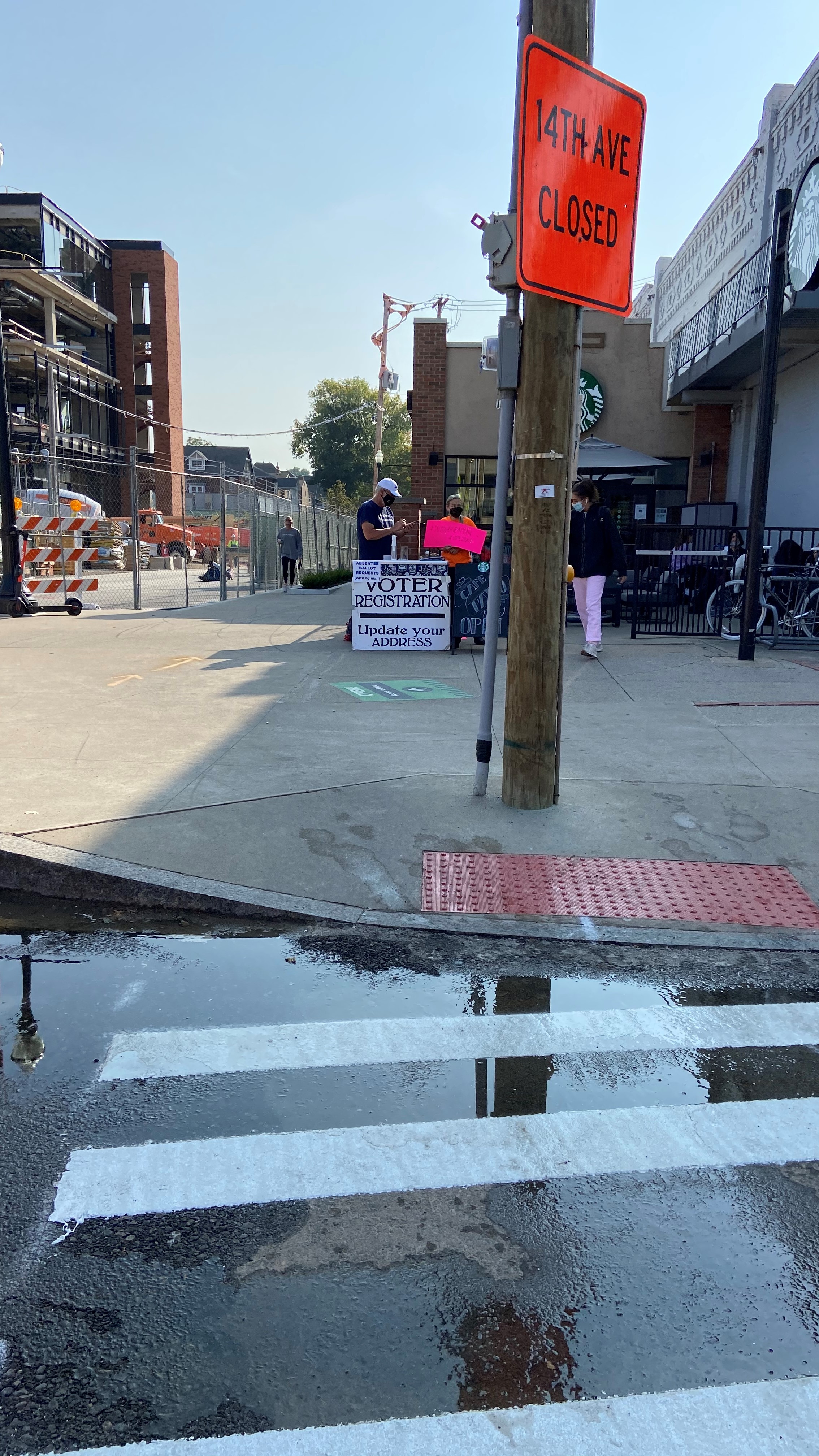 downtown street with voter registration sign 