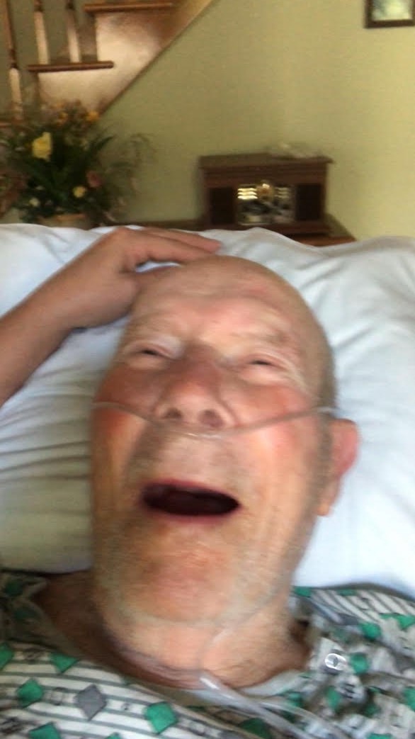 elderly white man smiling with oxygen tubes in nose