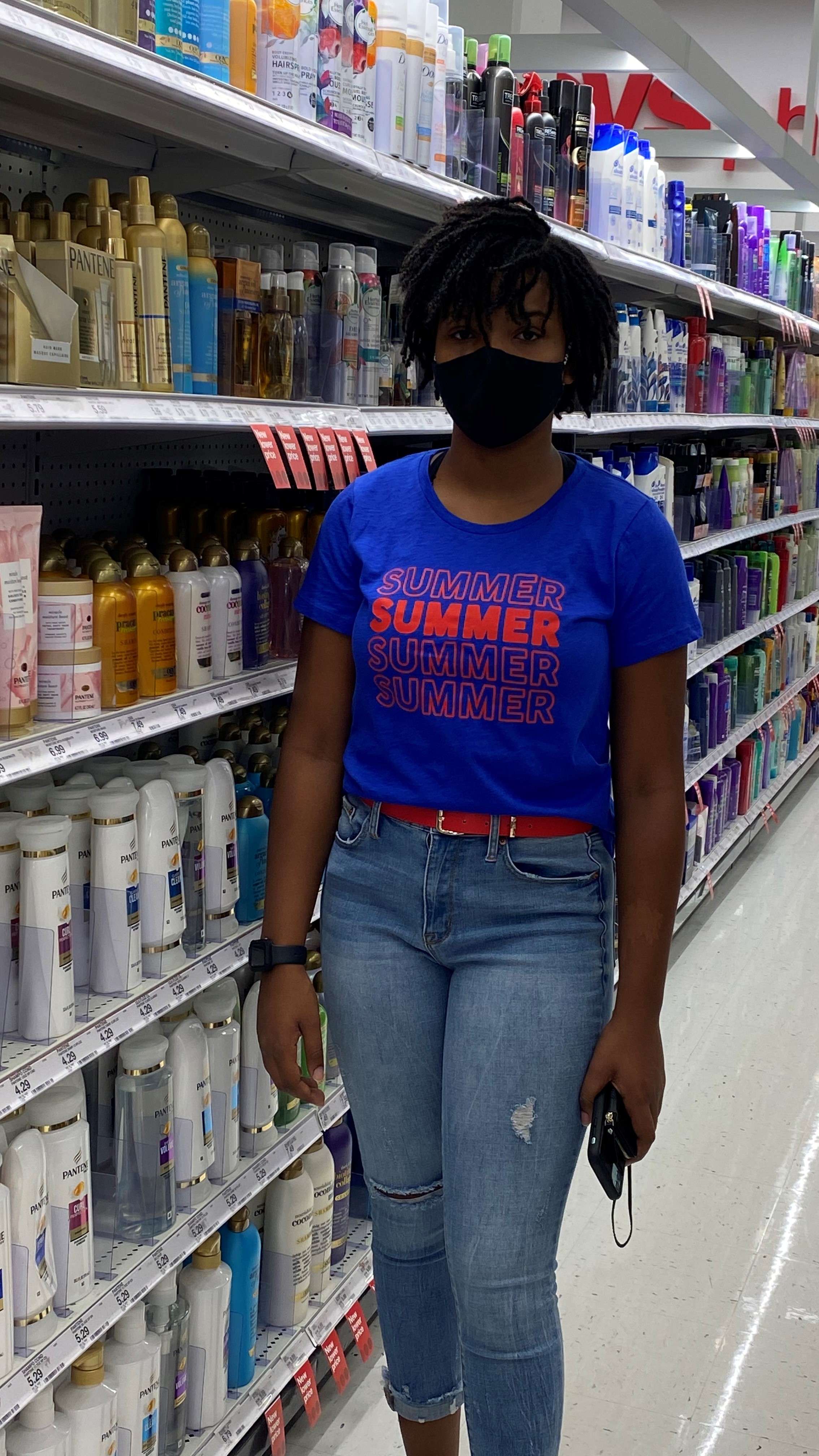 black woman standing in shampoo aisle at CVS drugstore