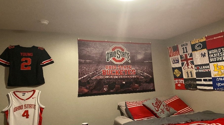 college dorm room with Ohio State memorabilia covering walls