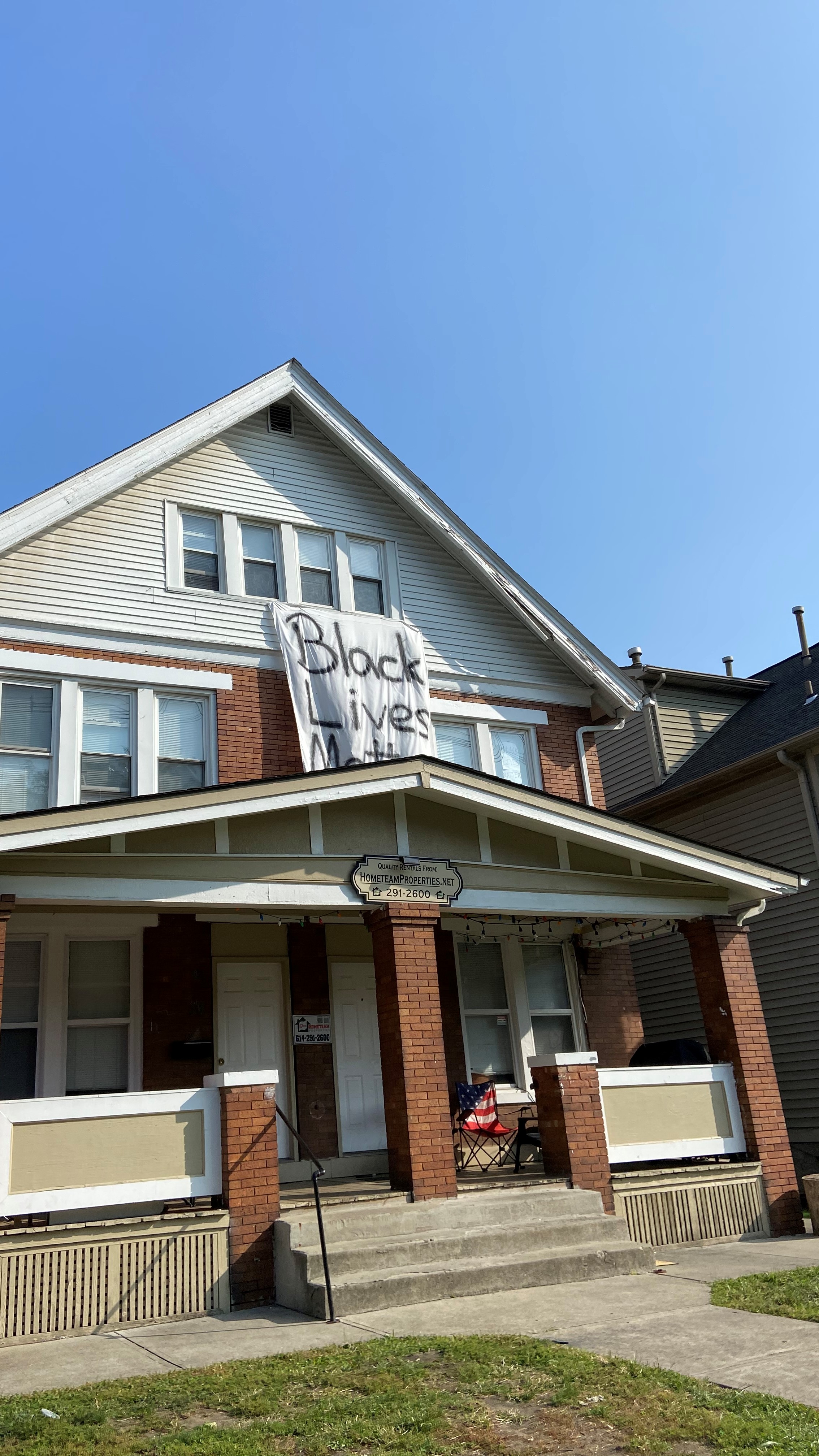 House with Black Lives Matter painted on a sheet hanging from window