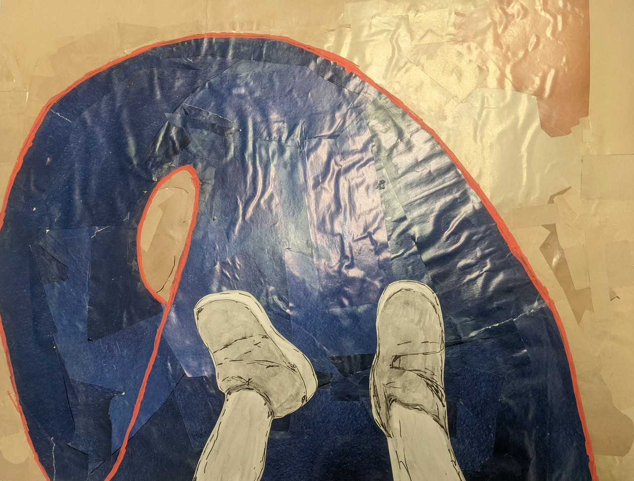Two feet stretched out on the top of a dark blue slide with orange border