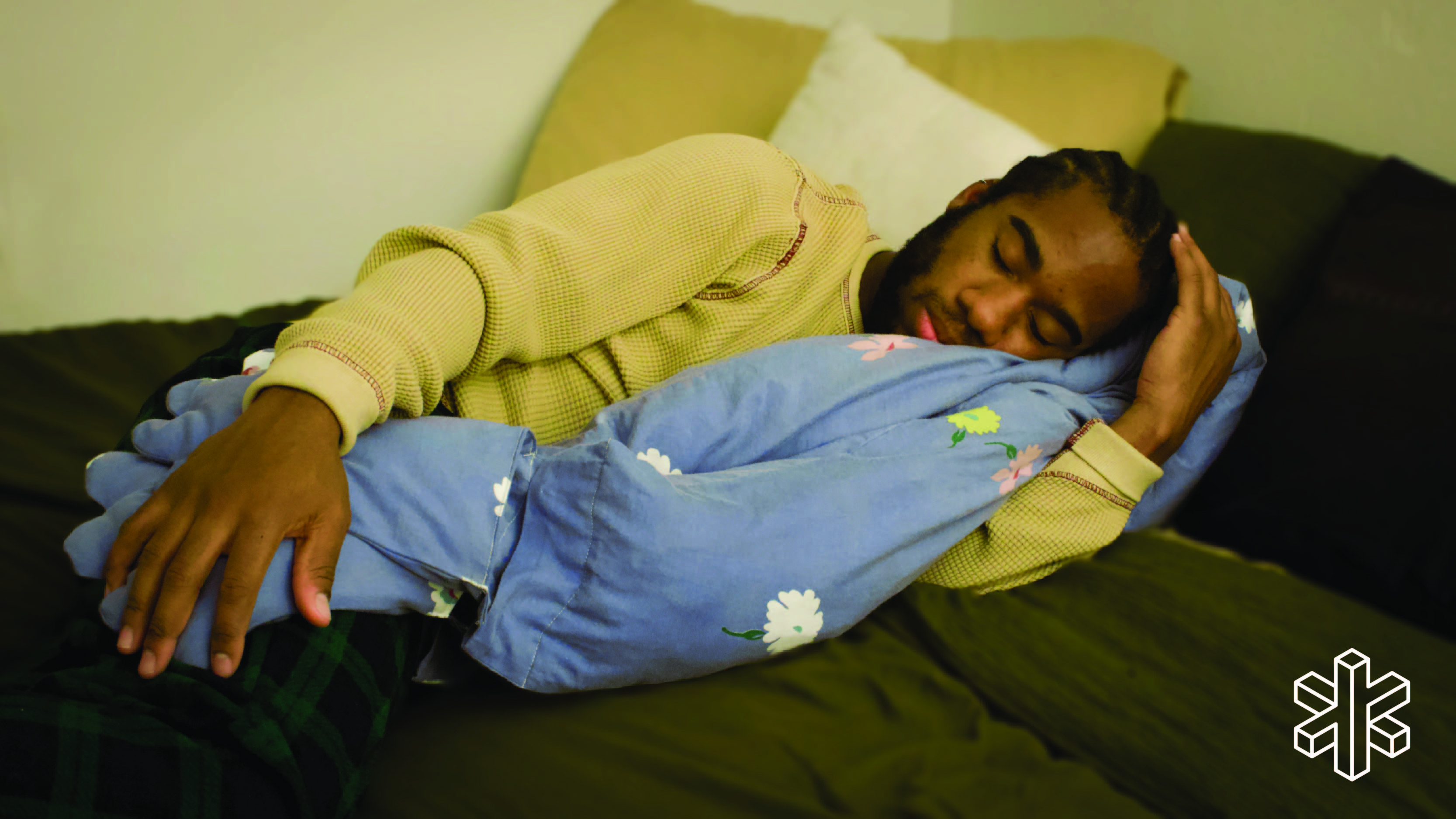 person sleeping with padded blue hands and arm