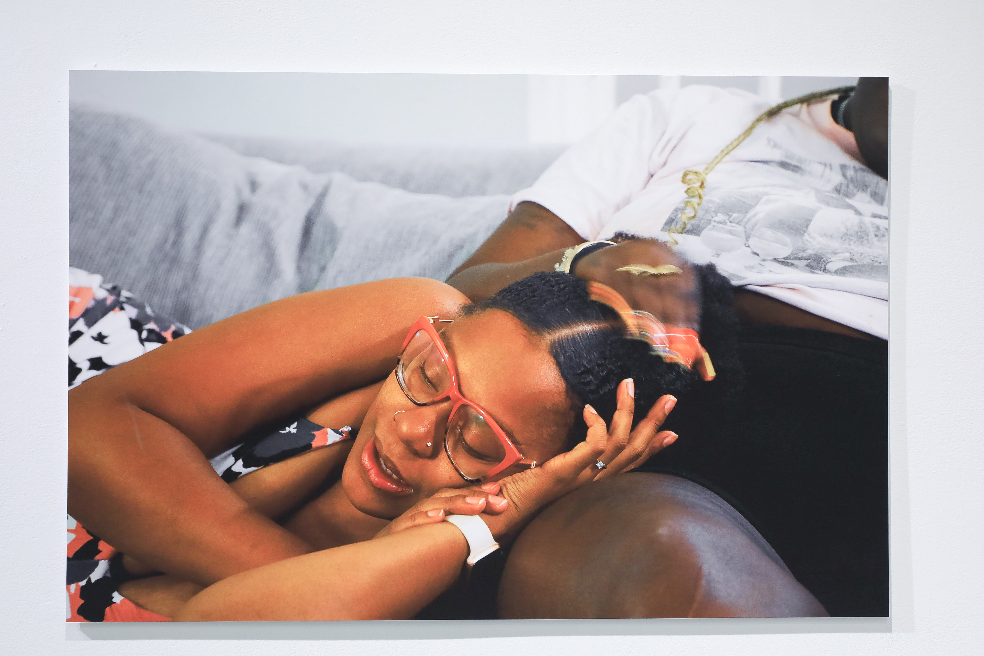 Ajanaé lying on a woman's leg as the woman caresses Ajanaé's head. 