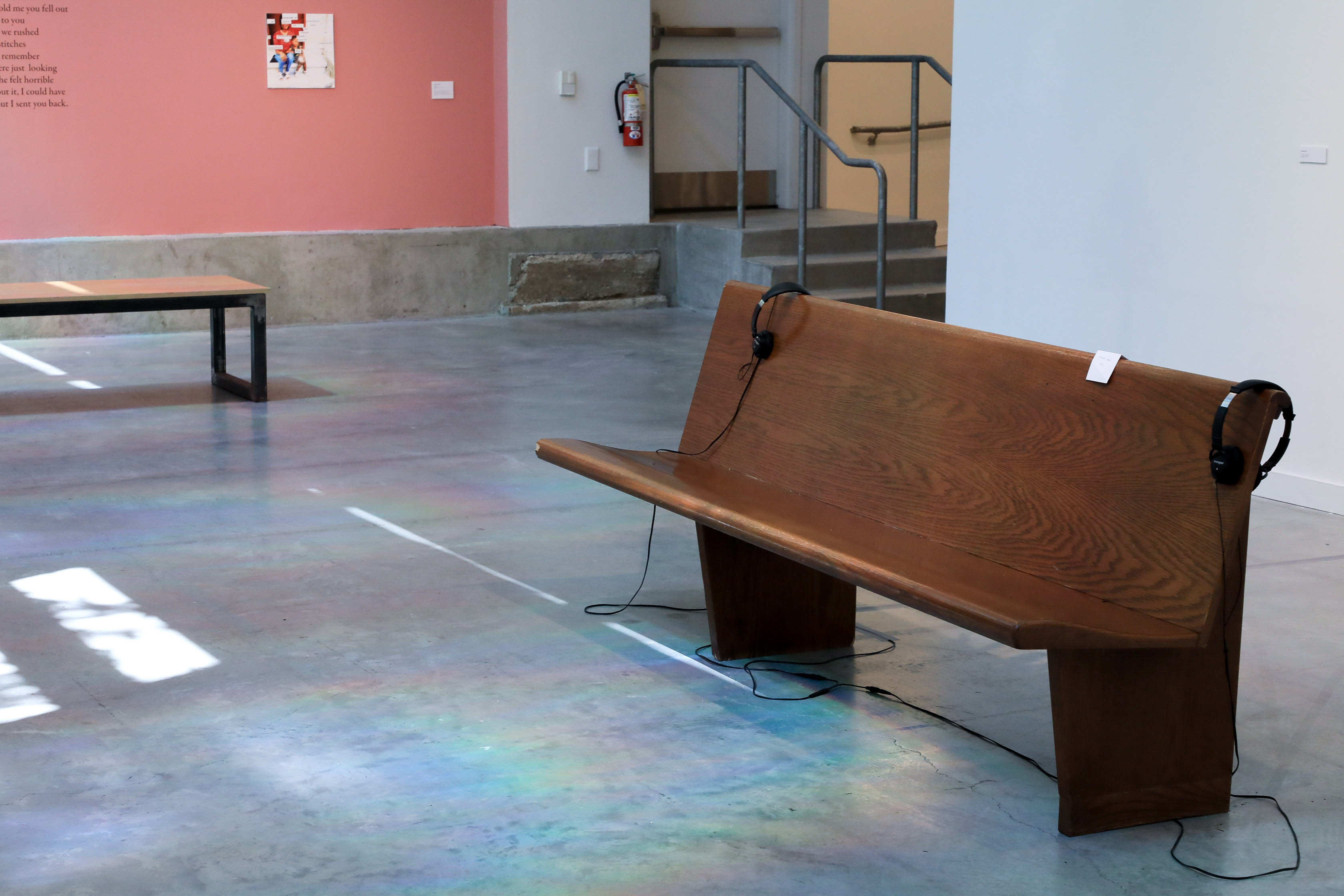 A church pew with headphones on top for engagement. 