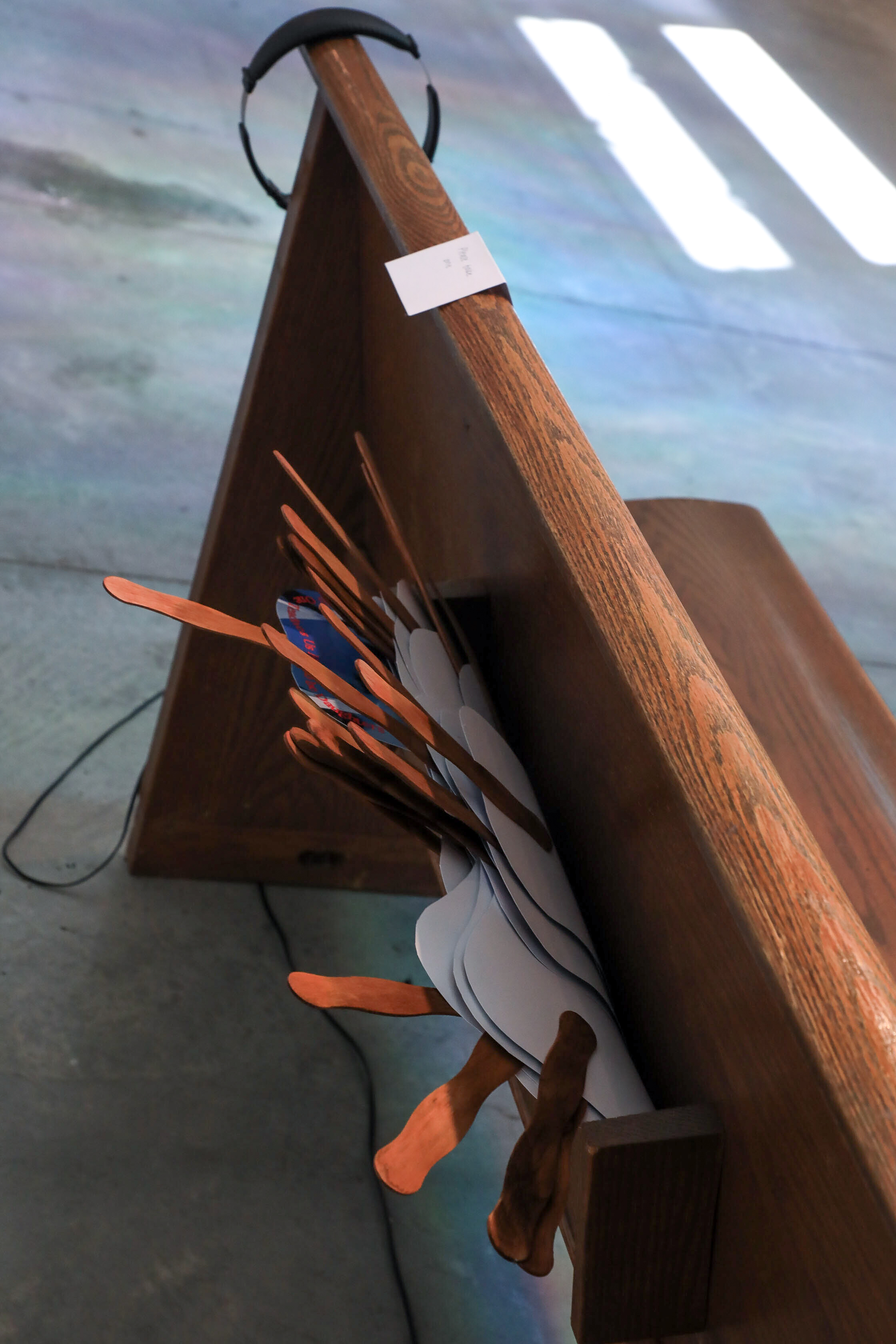 Church fans in the back of the church pew. 