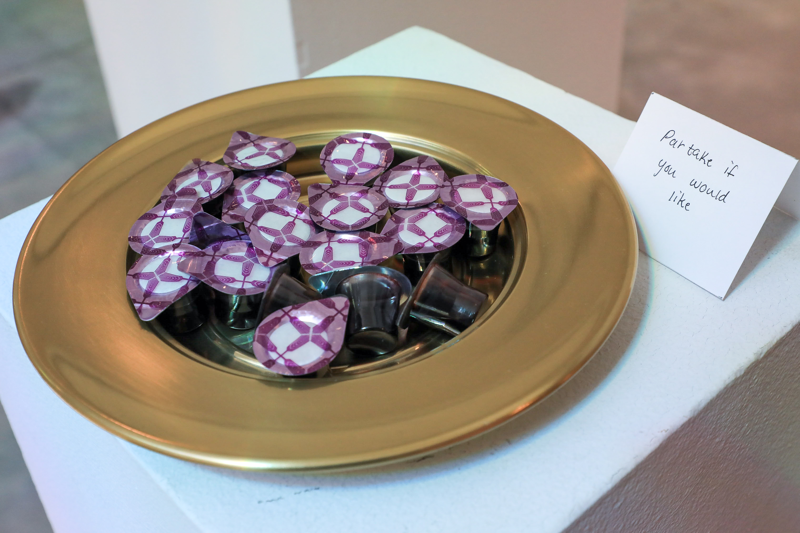 A golden plate with Communion cups for viewers to take. 