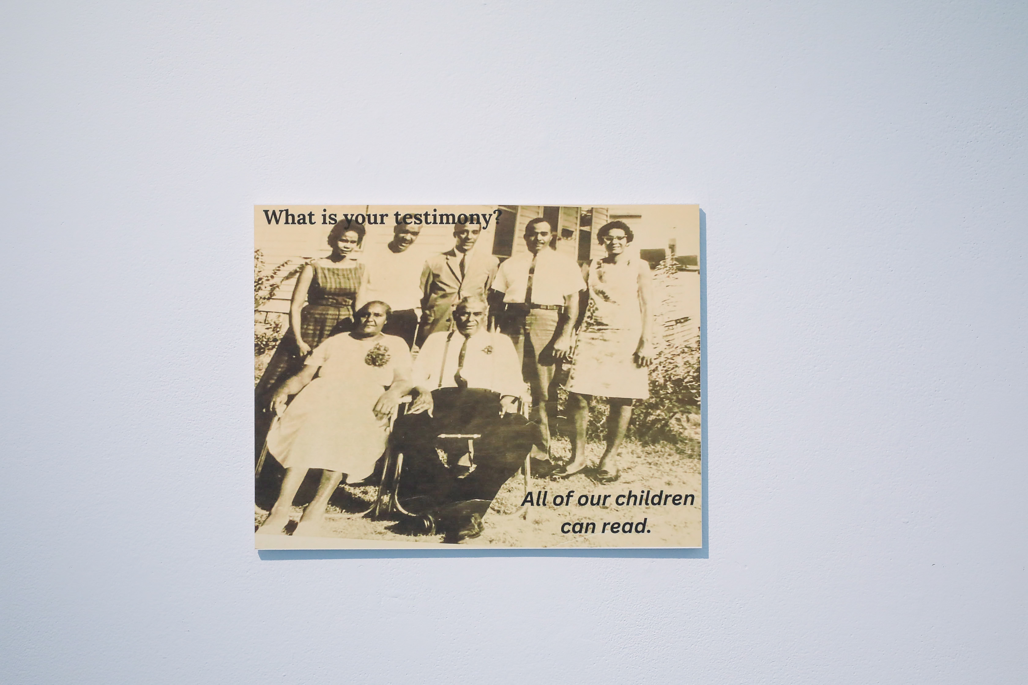 A vintage photo of Ajanaé’s family. Text says, “What is your testimony? All of our children can read.”