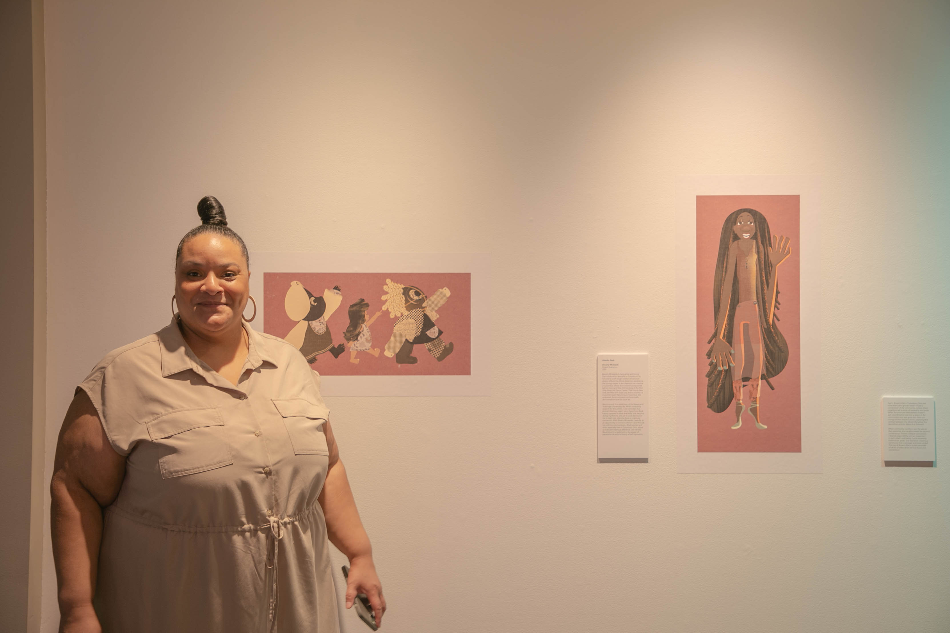 Aleesha Nash beside her illustrations