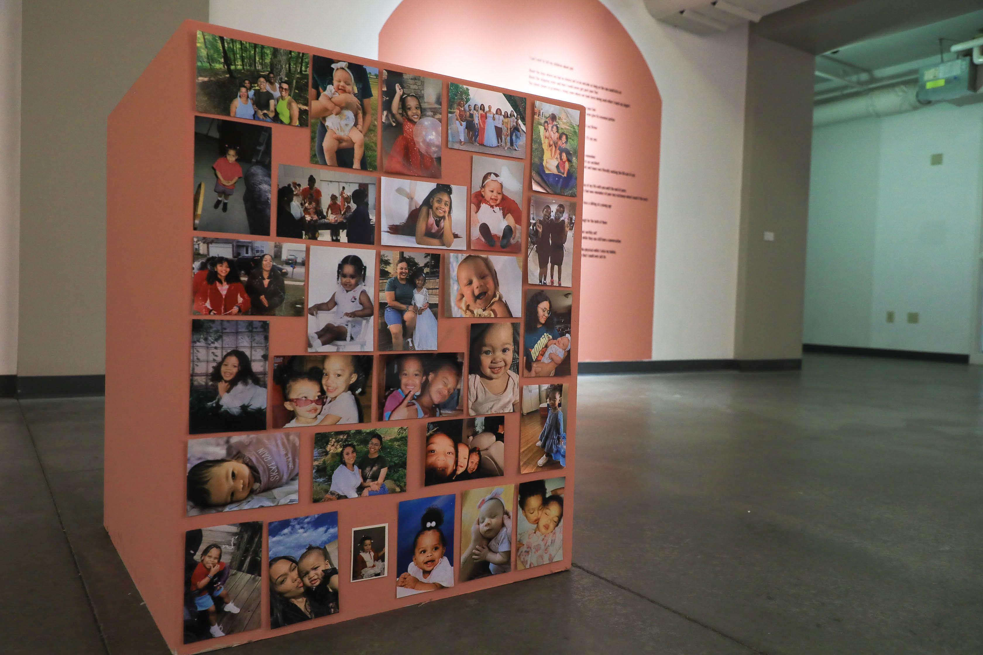 A red-orange box with several family photos on its front face. 