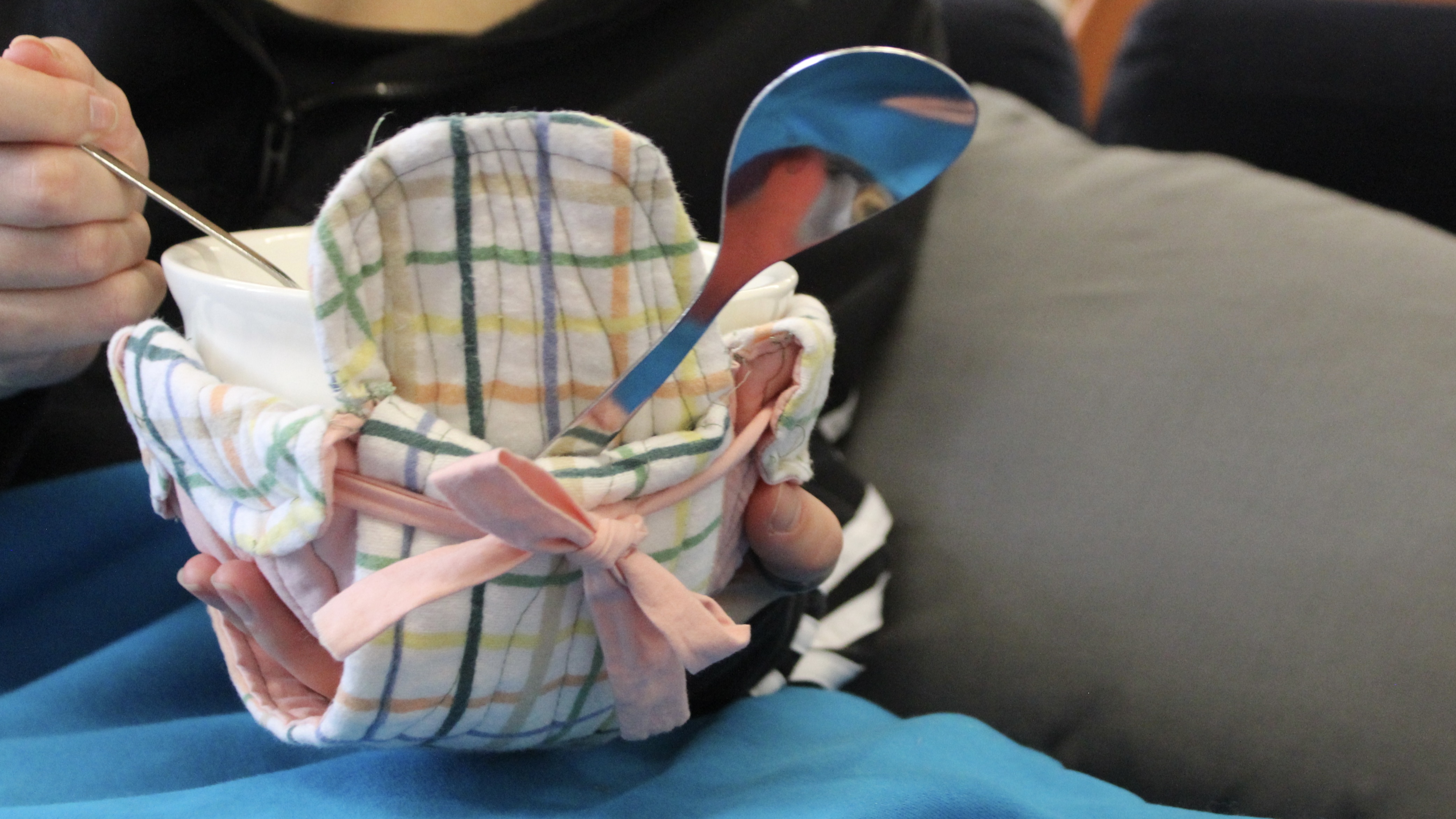 person holding a bowl inside a cotton bowl cozy