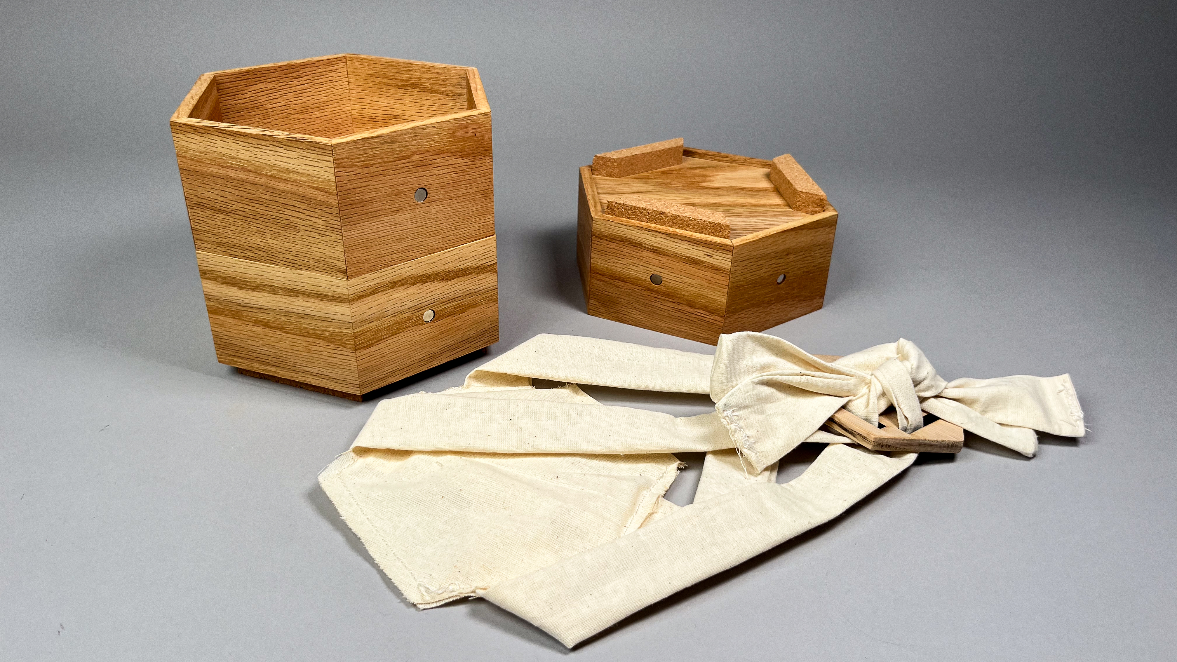 hexagonal wooden boxes next to white fabric