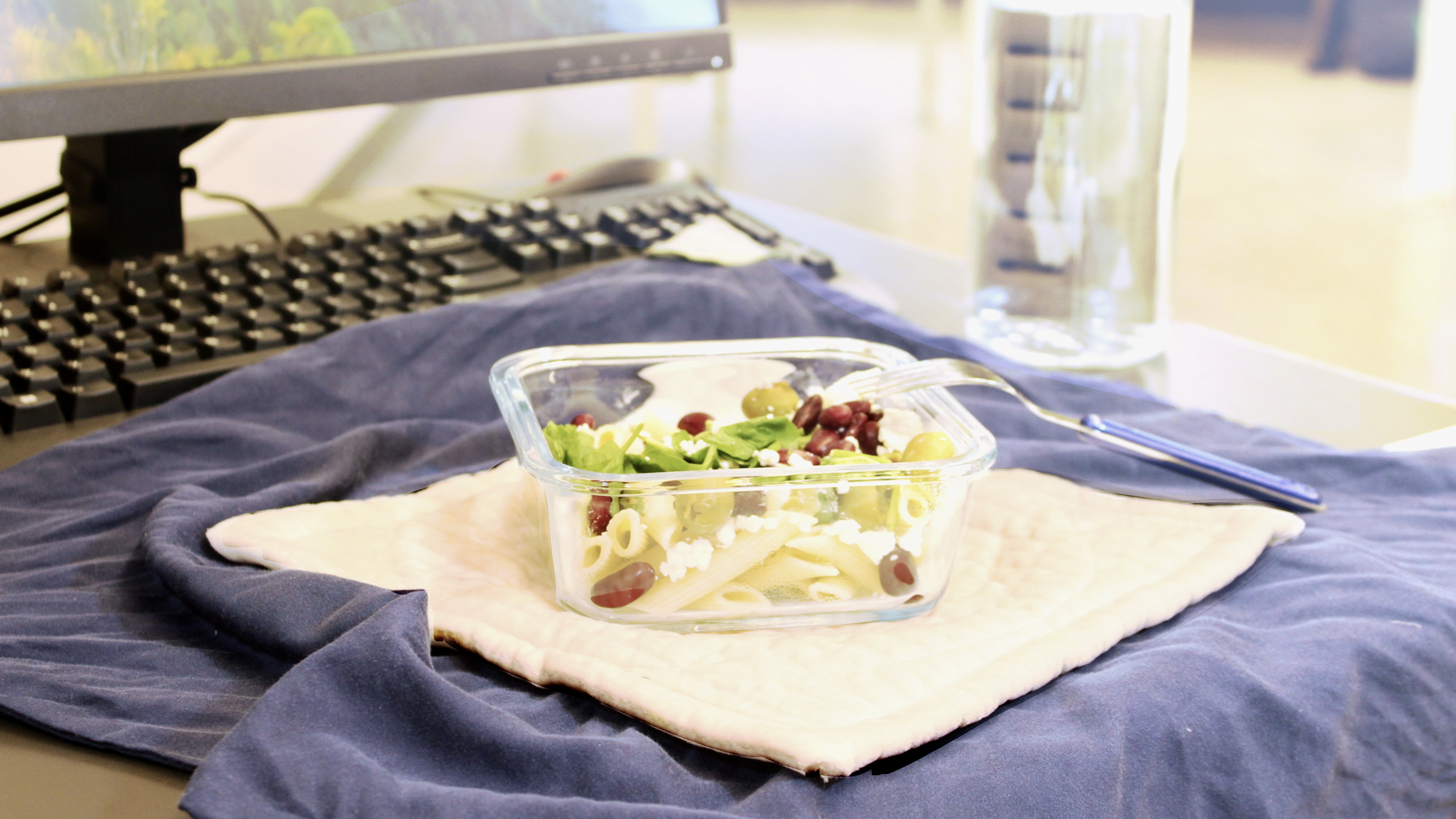 a packed lunch on a blue cloth