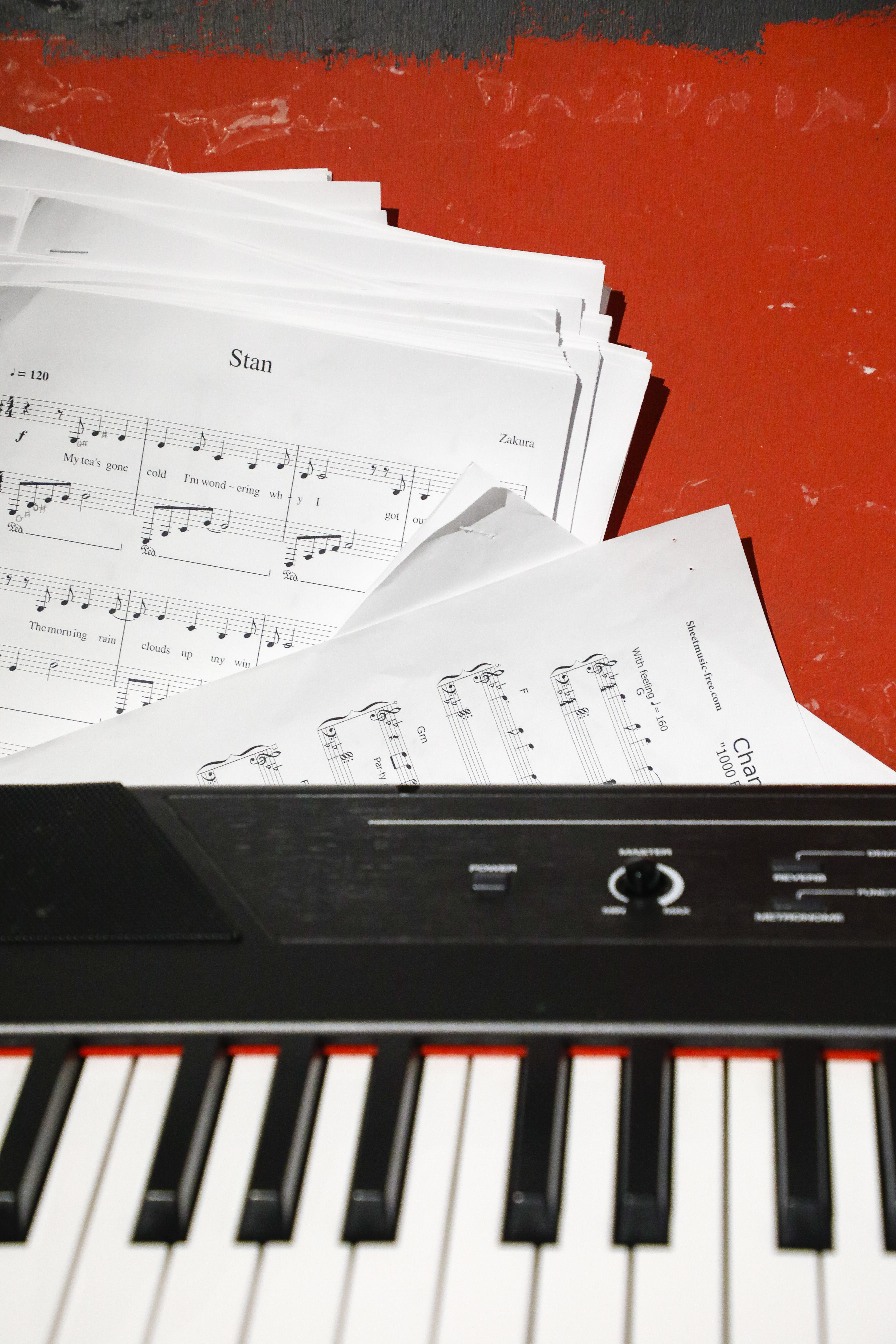 close up of a piano keyboard with sheet music