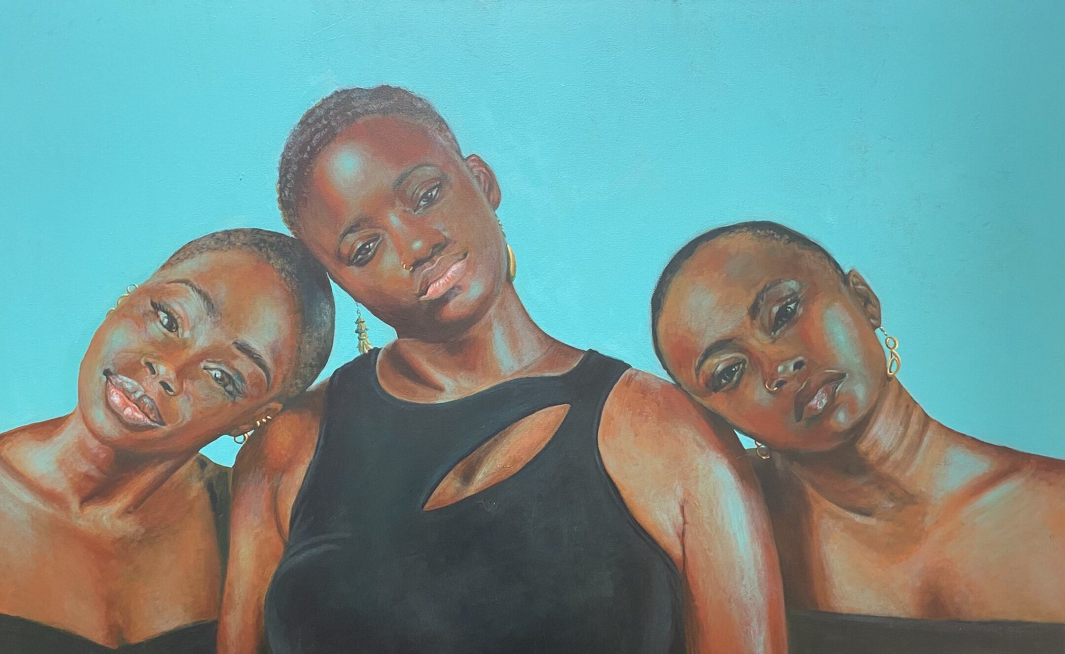 three women of color with short hair, black shirts, and gold earrings in front of a light blue background