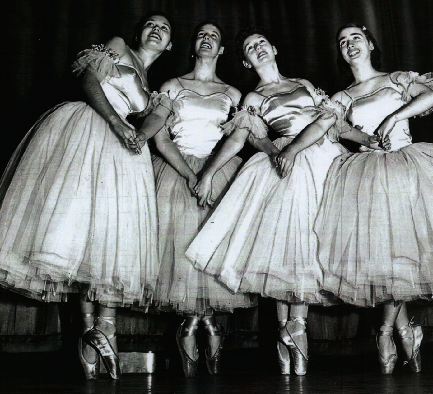 four dancers in white tutus