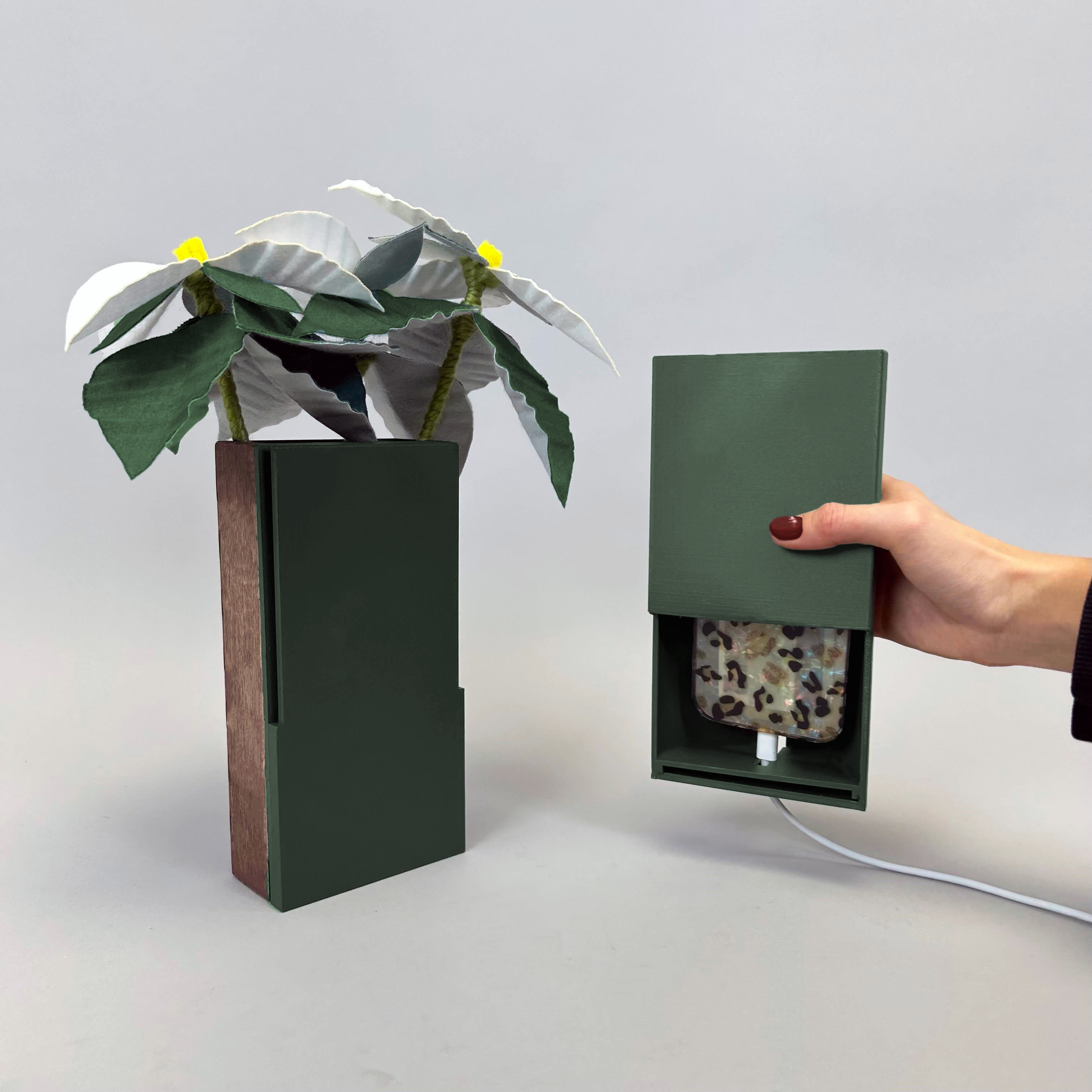 tall green container with felt flower used for holding a phone