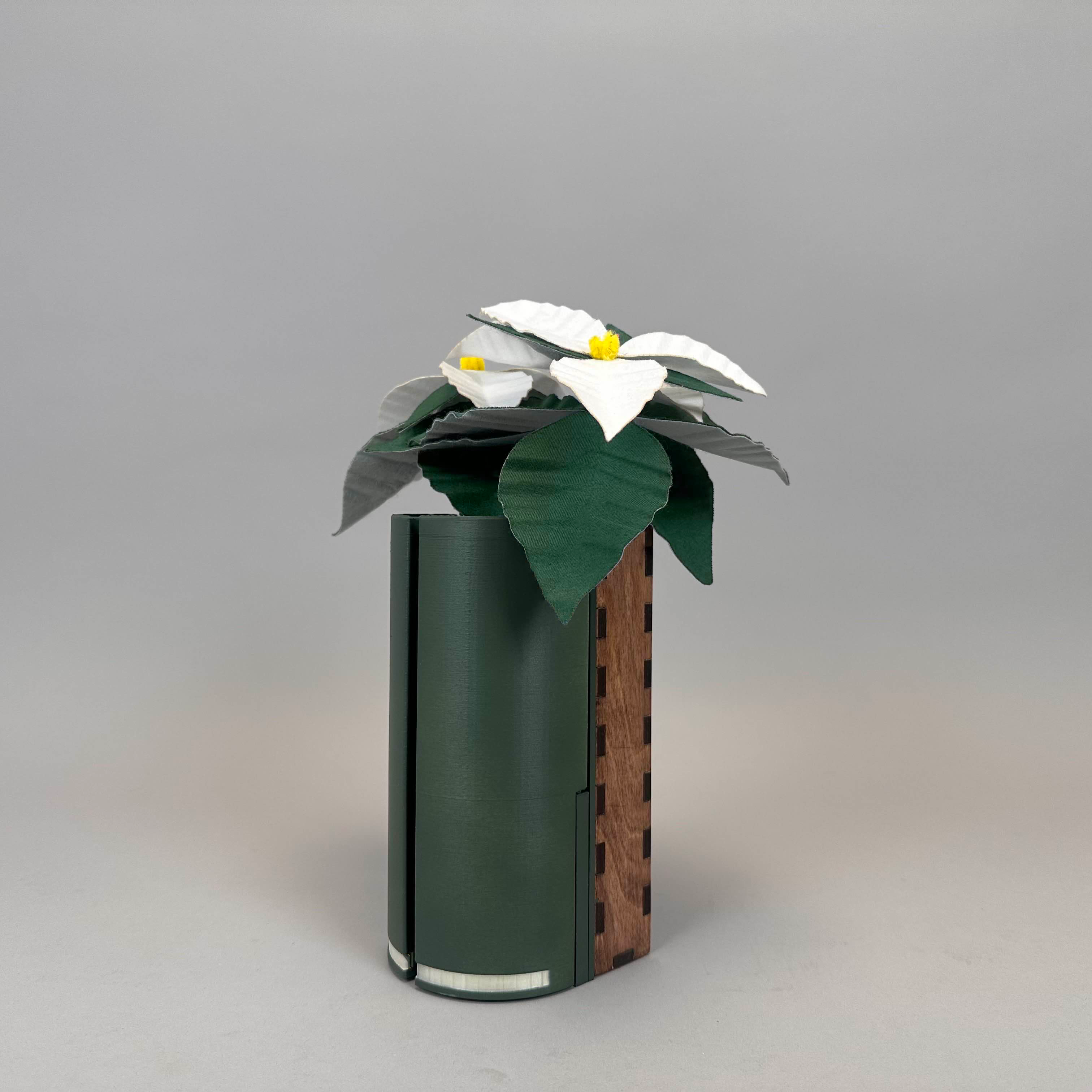 tall green container with felt flower used for holding a phone