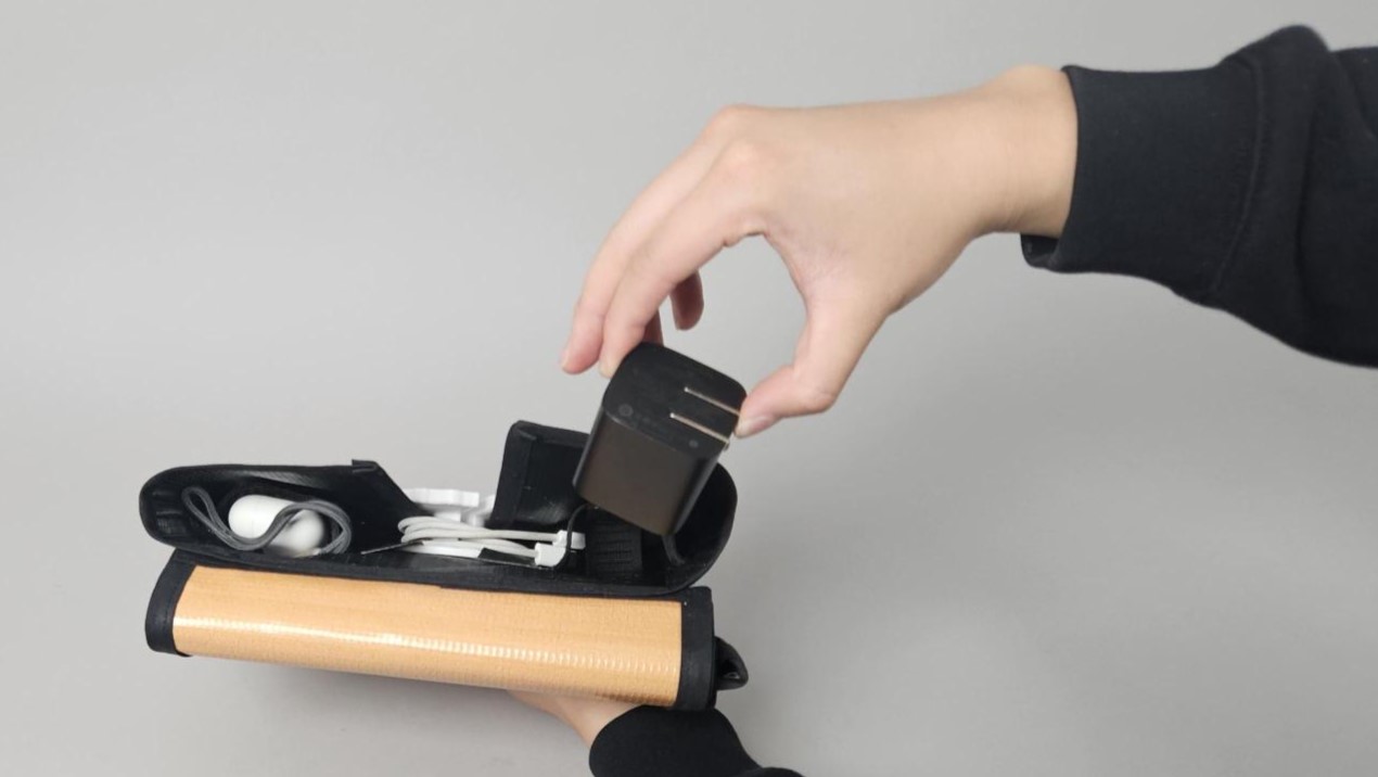 hand pulling cables from the pouch