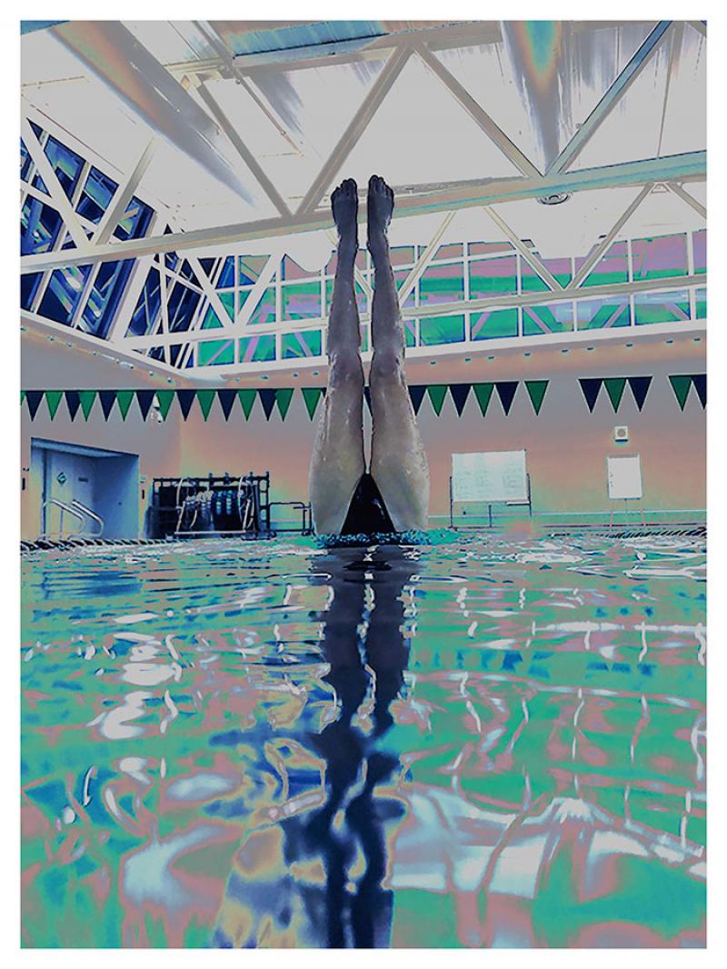 Swimmer's legs standing outside of pool