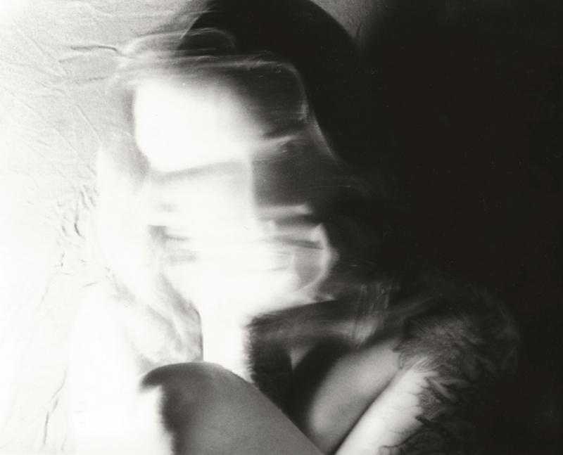 A black-and-white photo of a person with a blurry face