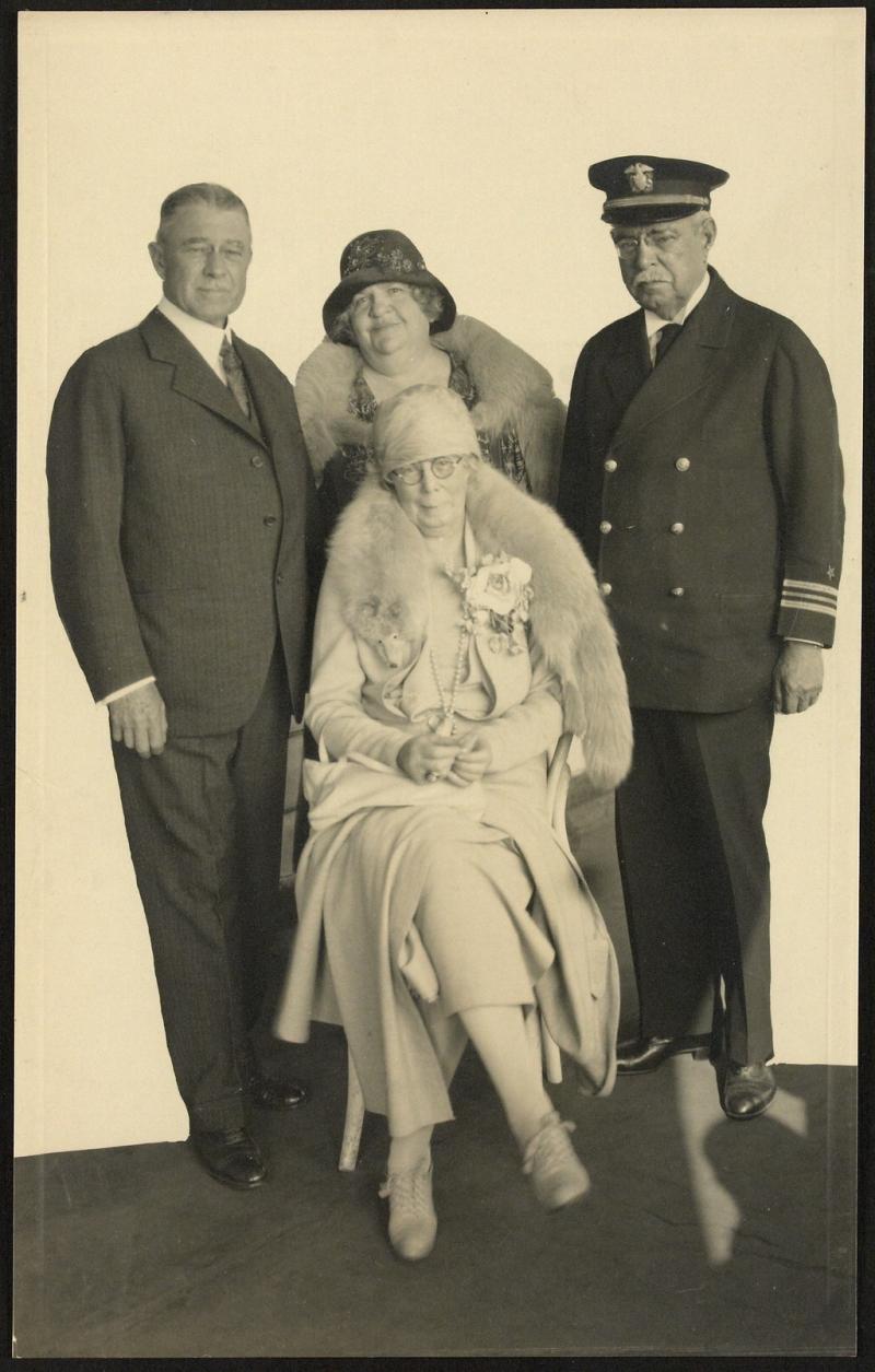 A sepia photograph with Carrie Jacobs Bond seated in front of John Philip Sousa and Mr. and Mrs. Herbert L. Clarke