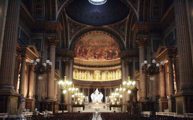 A large, dimly lit sanctuary inside a cathedral