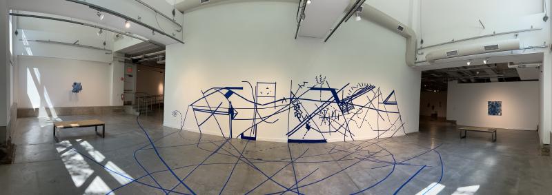 Wide-angle shot of the tape on the wall in every direction that was part of the artist's performance