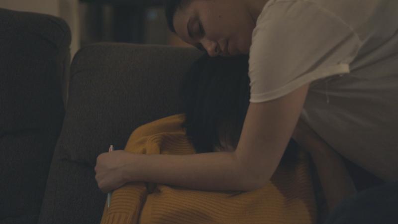 Film still of a woman hugging another woman 