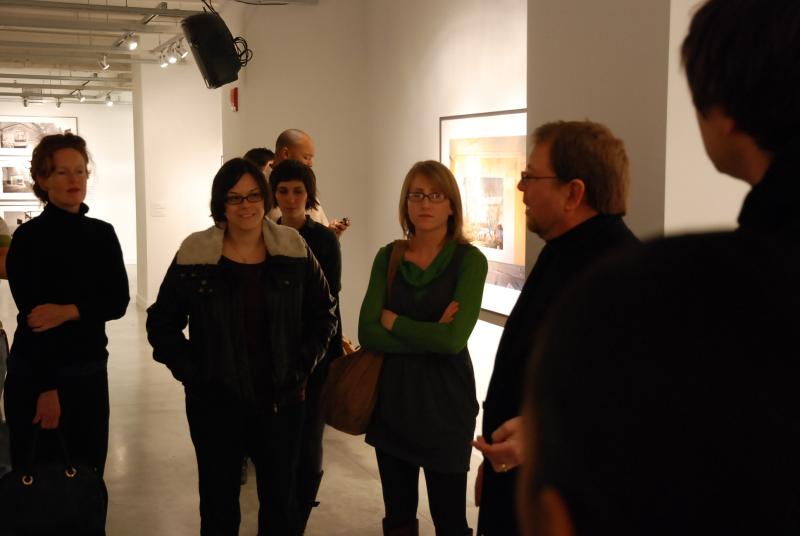 Fredrik Marsh discussing his work with attendees at a reception.