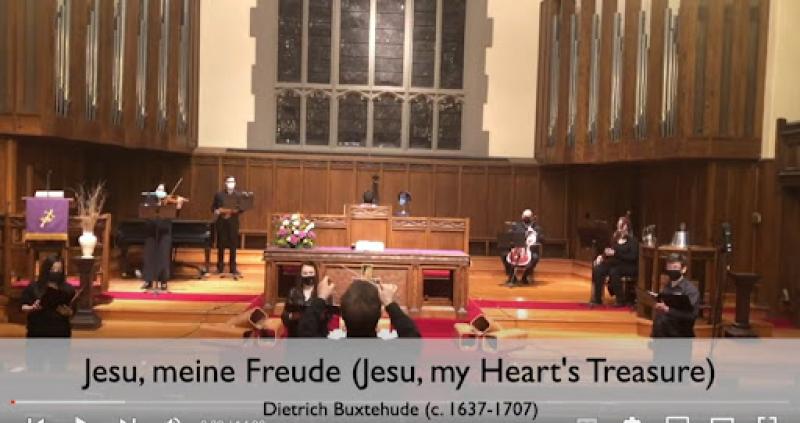 A screenshot of a YouTube video of several musicians on a church sanctuary stage