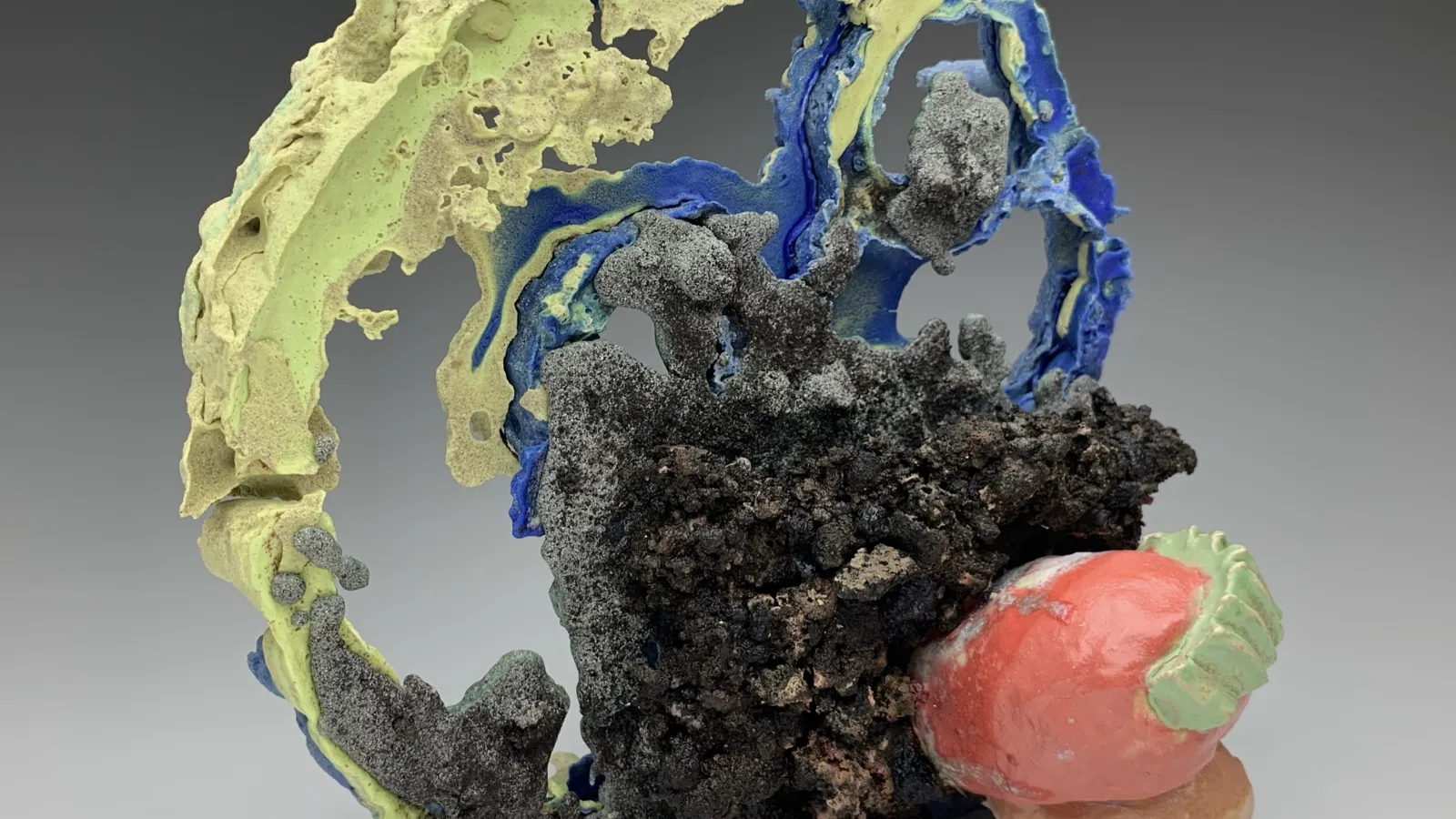 Blue, green, red, and black abstract sculpture.