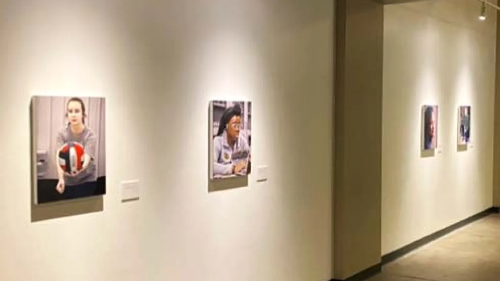Portraits in the Behind the White Coat exhibition hanging on the wall