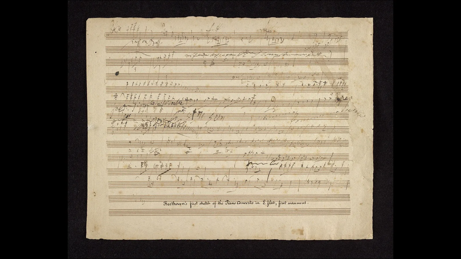 A yellowed piece of sheet music with handwritten music notes and words