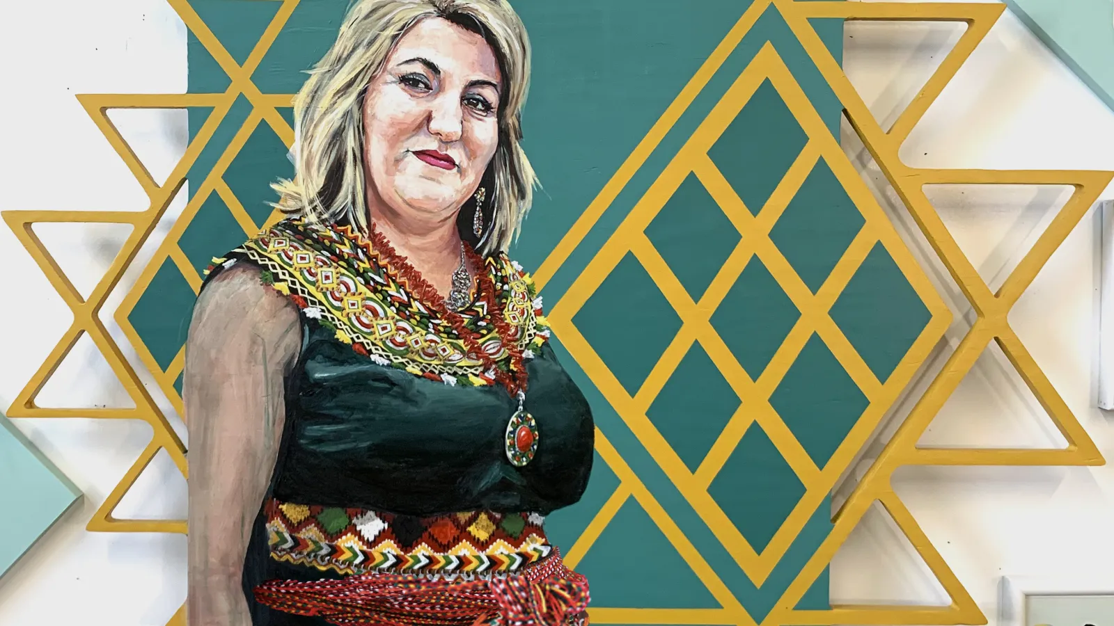 Painting of a woman in front of a gold geometric pattern