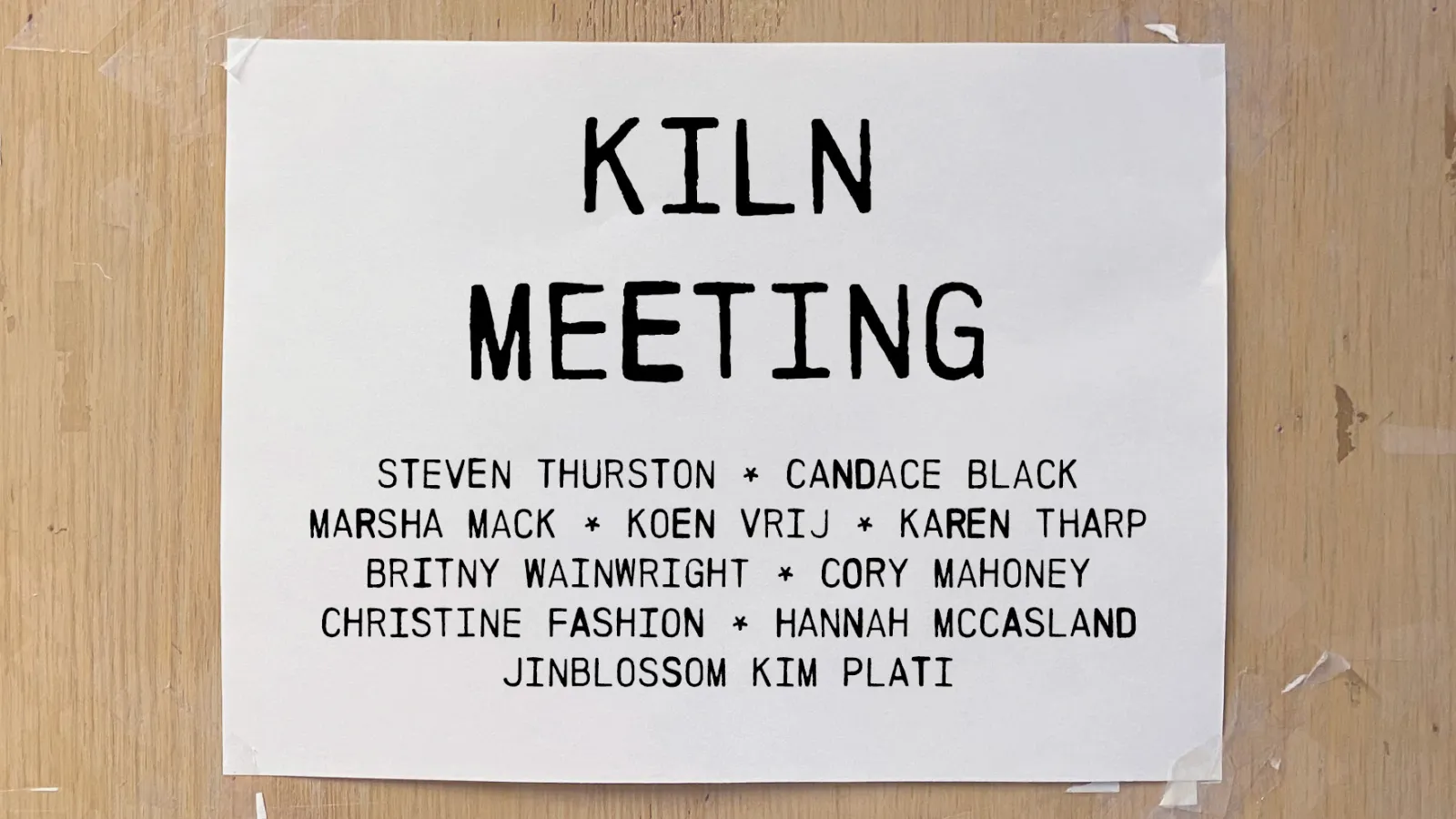 White paper with brown background with the words ‘Kiln Meeting’