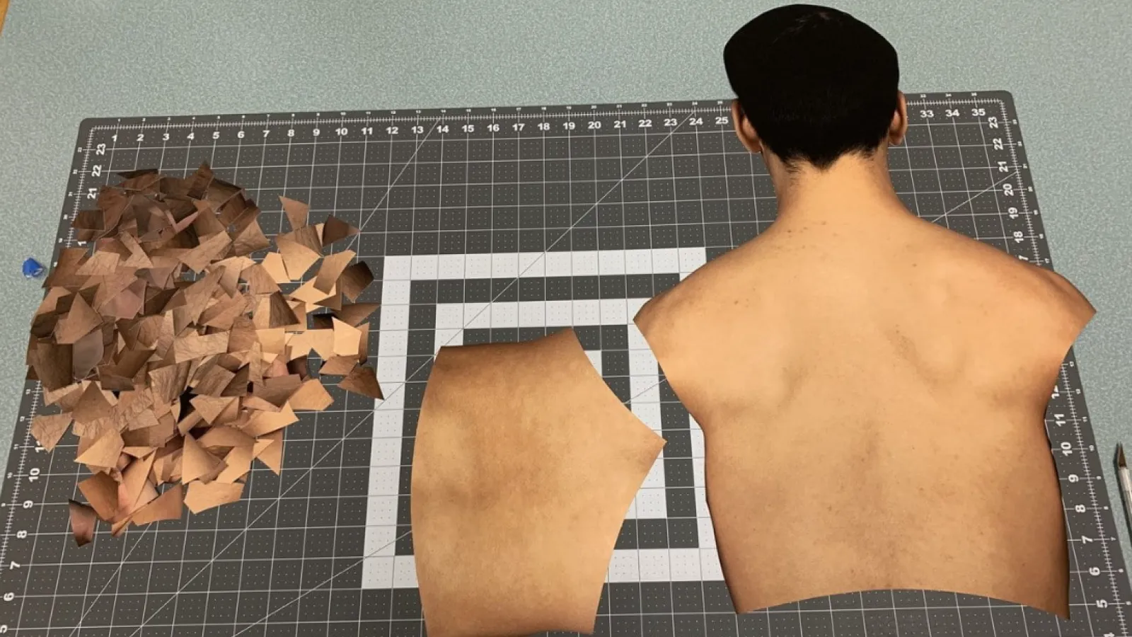 A photo showing a work in progress of a collage work by Samuel Lo, featuring a human torso