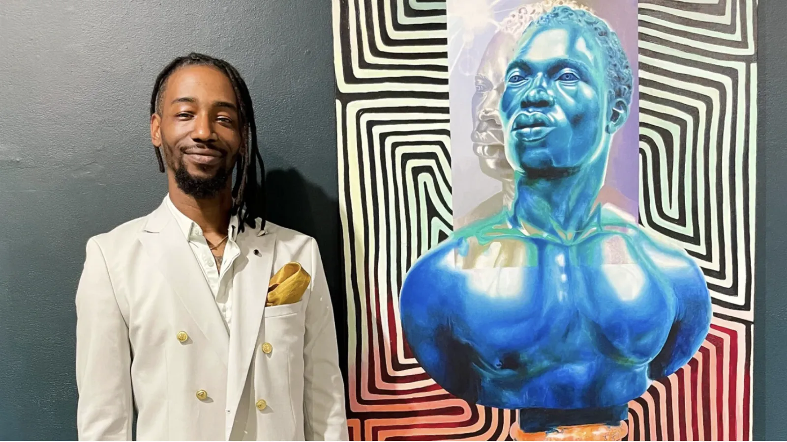 photo of Arris' beside one of his paintings