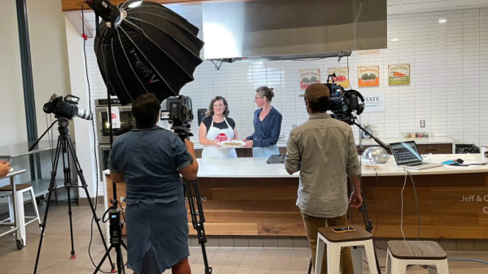Merijn and Kate hold a plate of cookies as the camerapeople reocrd
