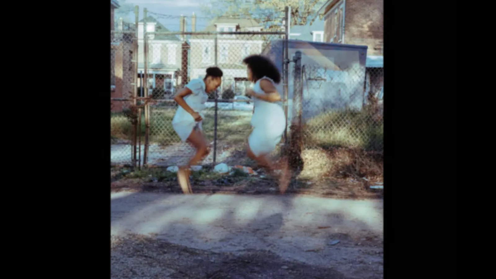 A photographic work by Ky Smiley, depicting two children jumping in the air
