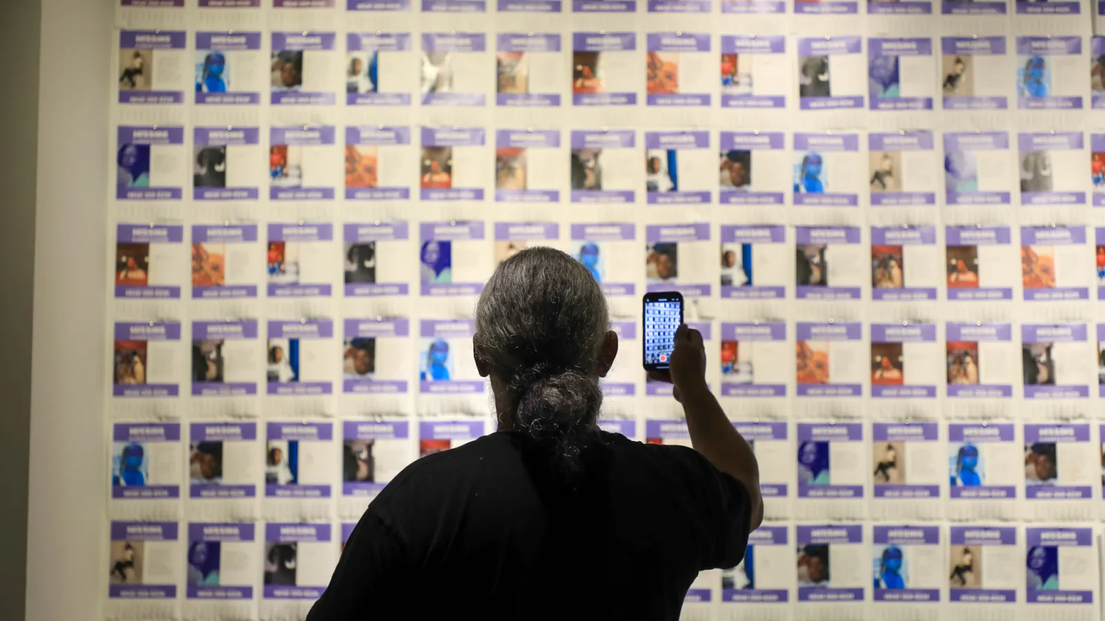 Viewer takes photo of Ajanaé's work "Missing"