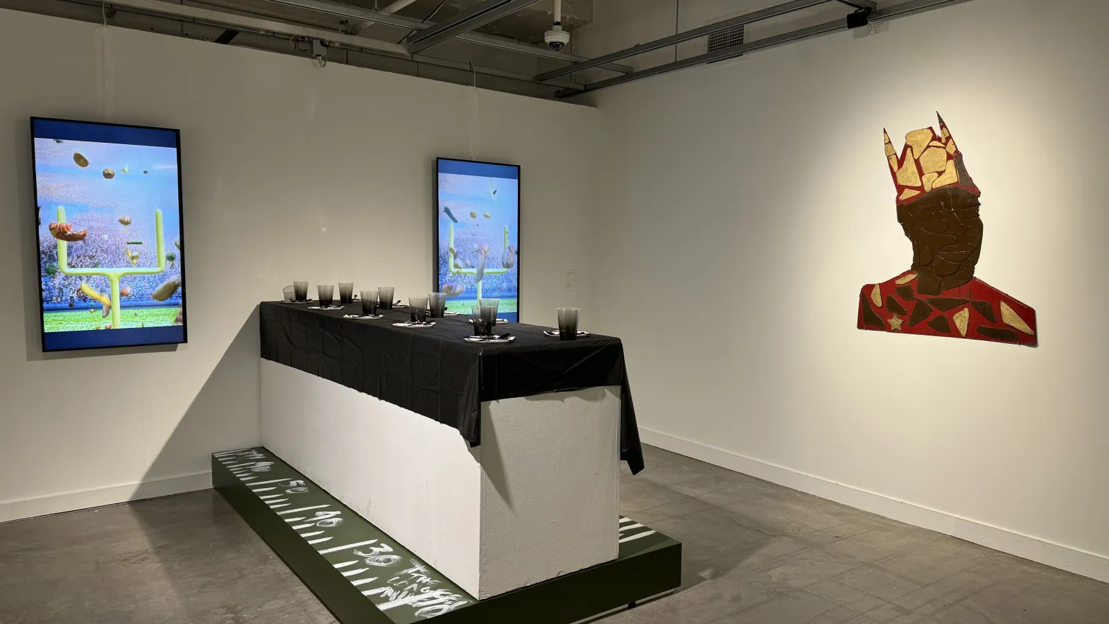 Table setting with a plywood art piece of a person with a crown