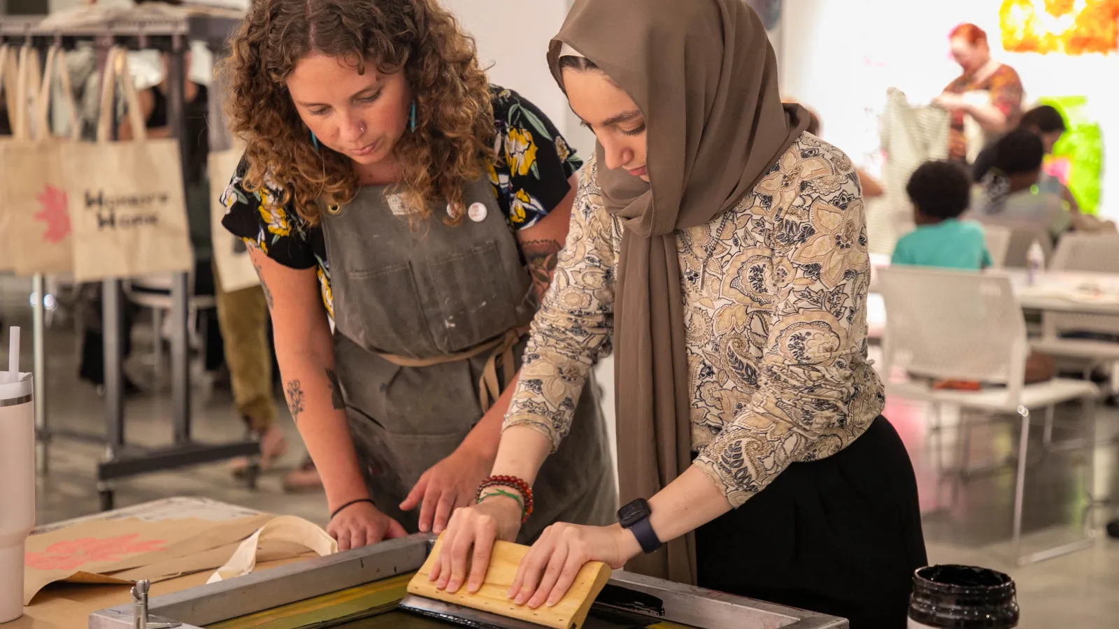 an intern screenprinting with an artist