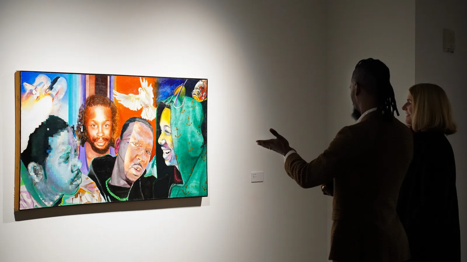 Arris' Cohen looking at his piece "Bruce" with a viewer.