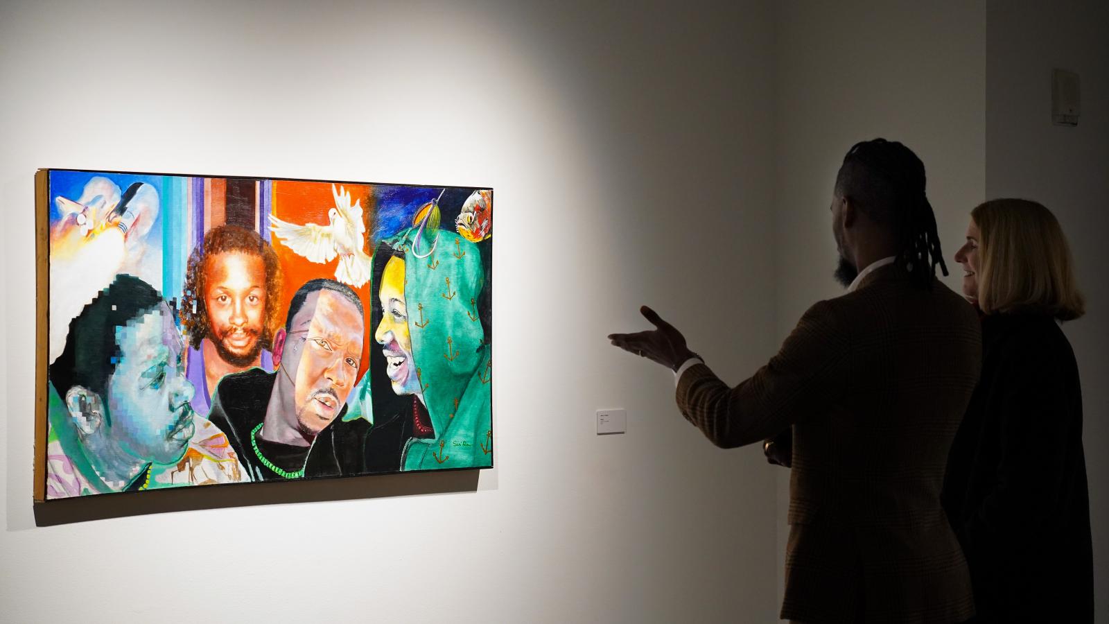 Arris' Cohen looking at his piece "Bruce" with a viewer.