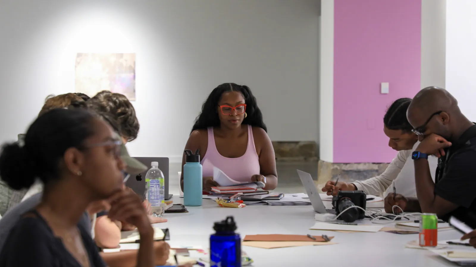 Ajanae at the head of a poetry workshop table