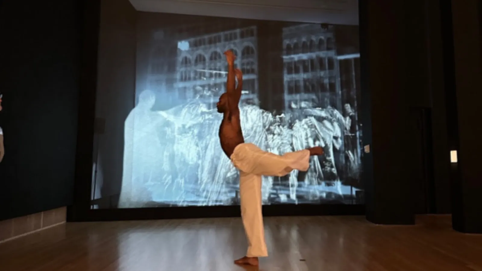 a person dancing with a leg and arms raised
