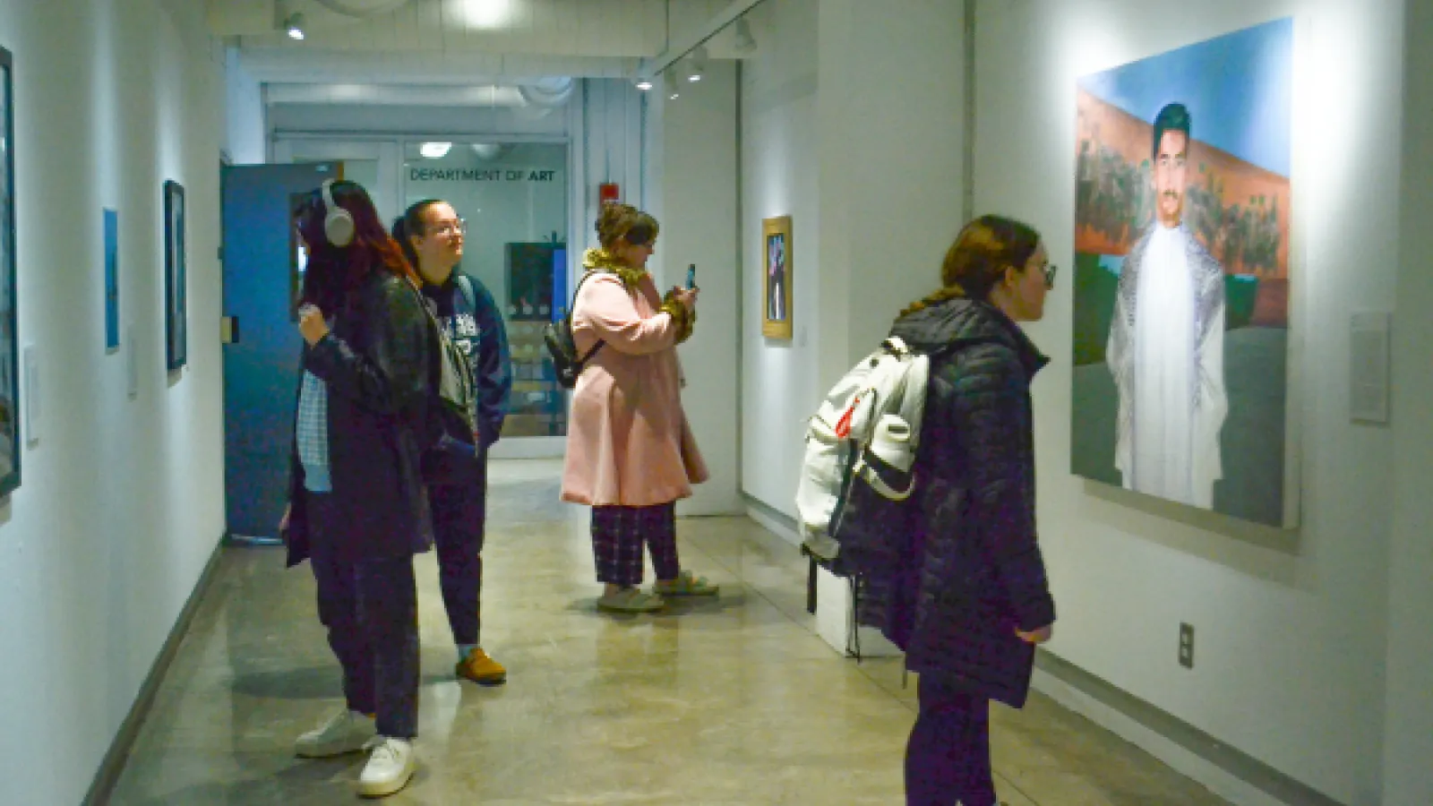 visitors looking at art in the corridor at hopkins hall