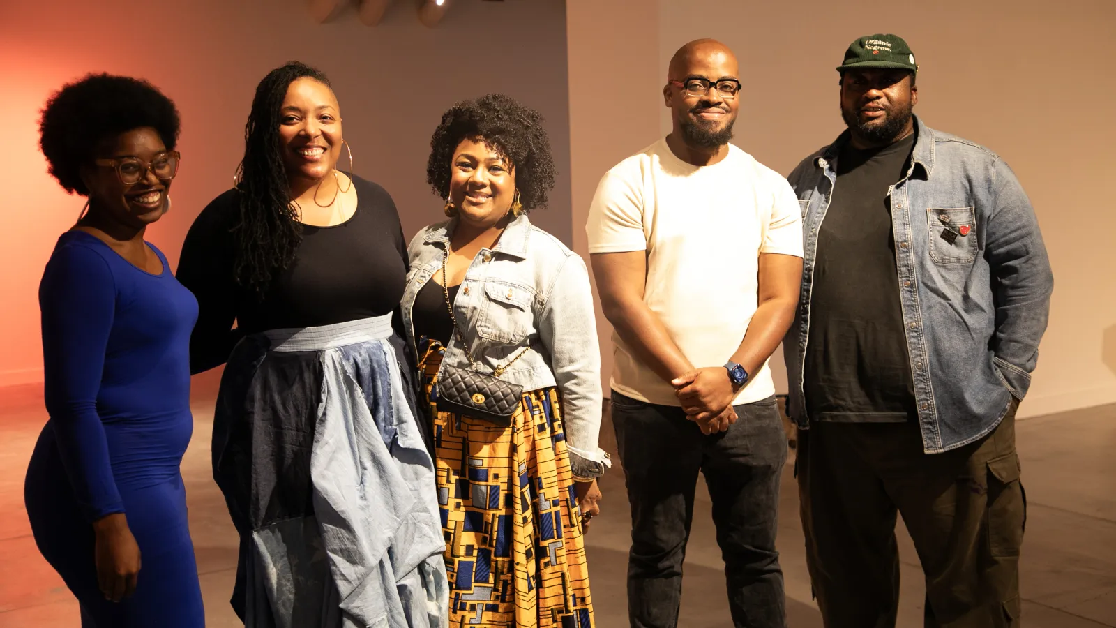 Five artists smiling at the camera 