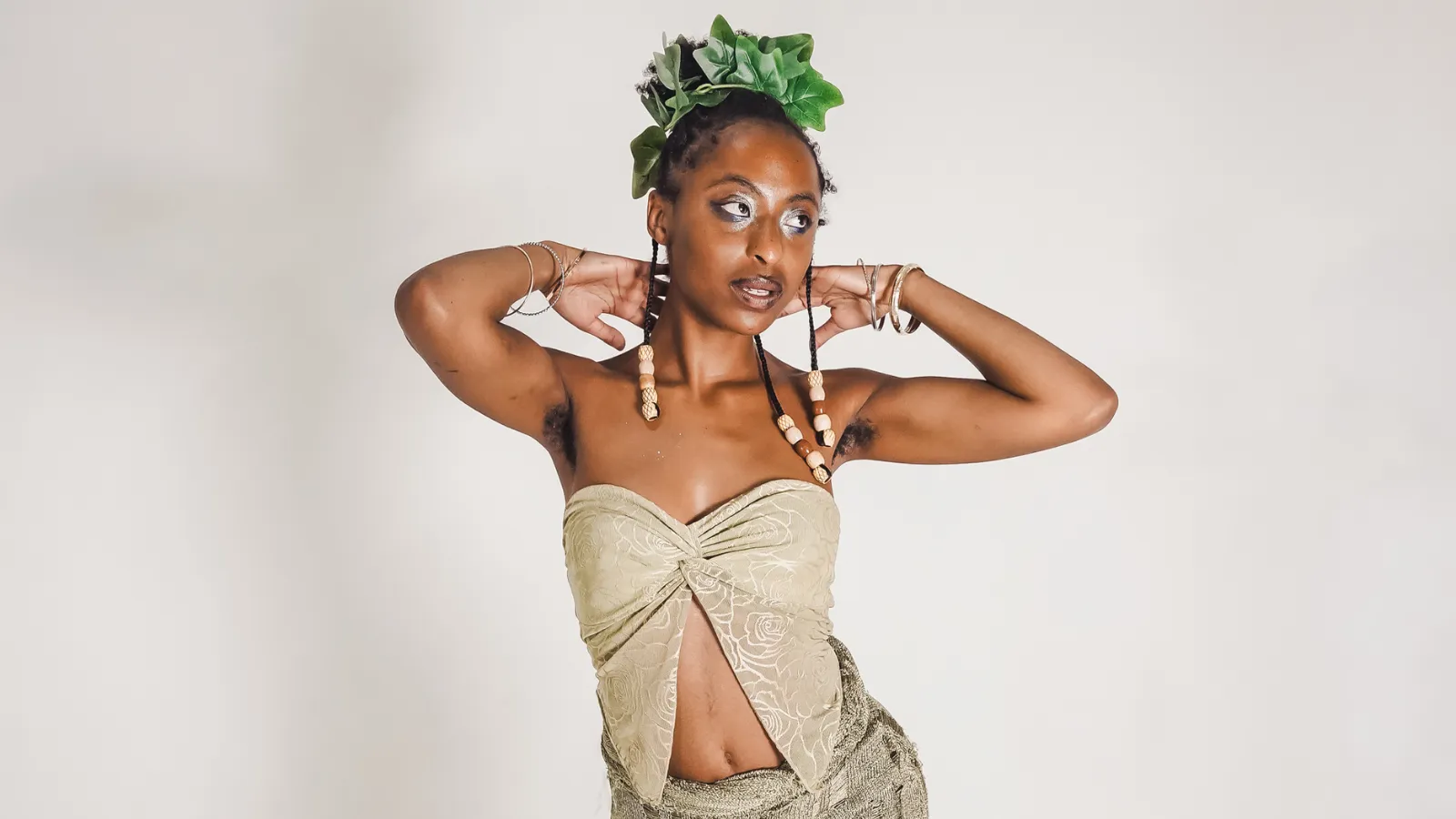 Gia sol posing in a white top and green crown